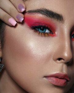 Womans face with red pink makeup